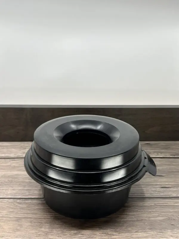 A Black Color Pet Food Bowl on a Wooden Surface